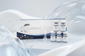 Curenex eye drop packaging set featuring a product box, several small vials, and a dropper, styled with flowing translucent blue liquid and gold sparkles on a light gray background.