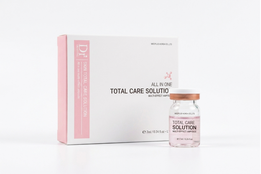 A white and pink box labeled 'DR Total Care Solution' stands next to a small glass vial with a rose-gold cap on a clean white background.