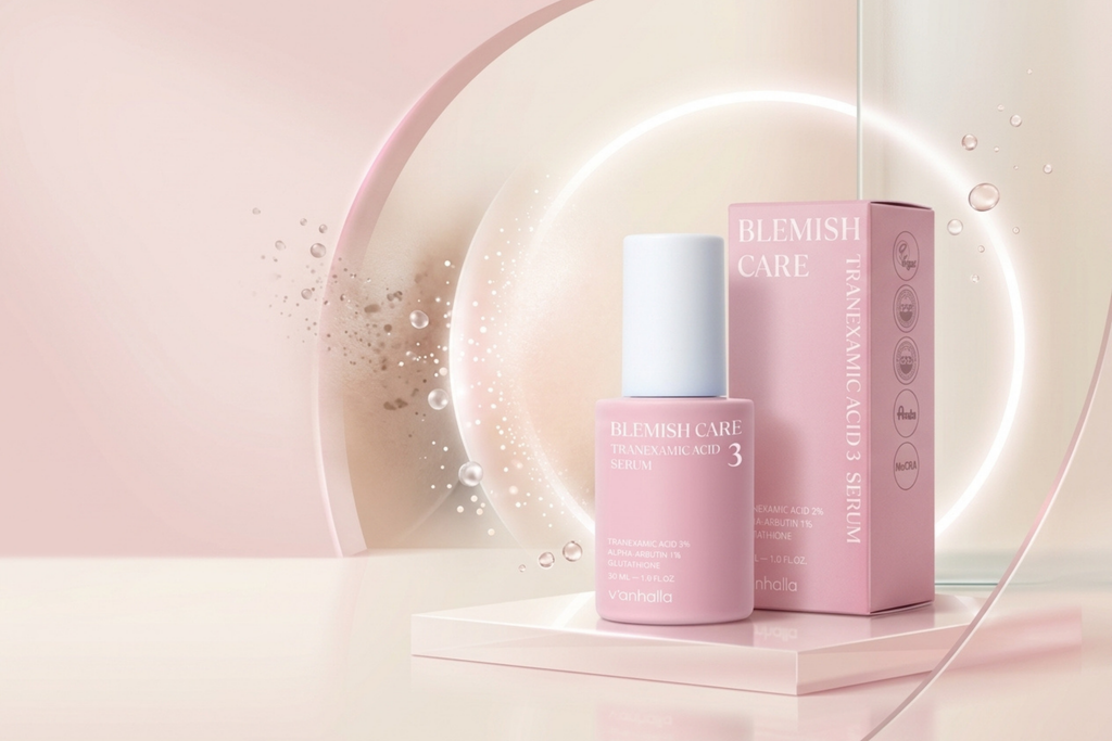 Blemish Care Radiance Glow Serum bottle and matching pink box displayed on a pedestal with a soft pink studio background and glowing circular light.